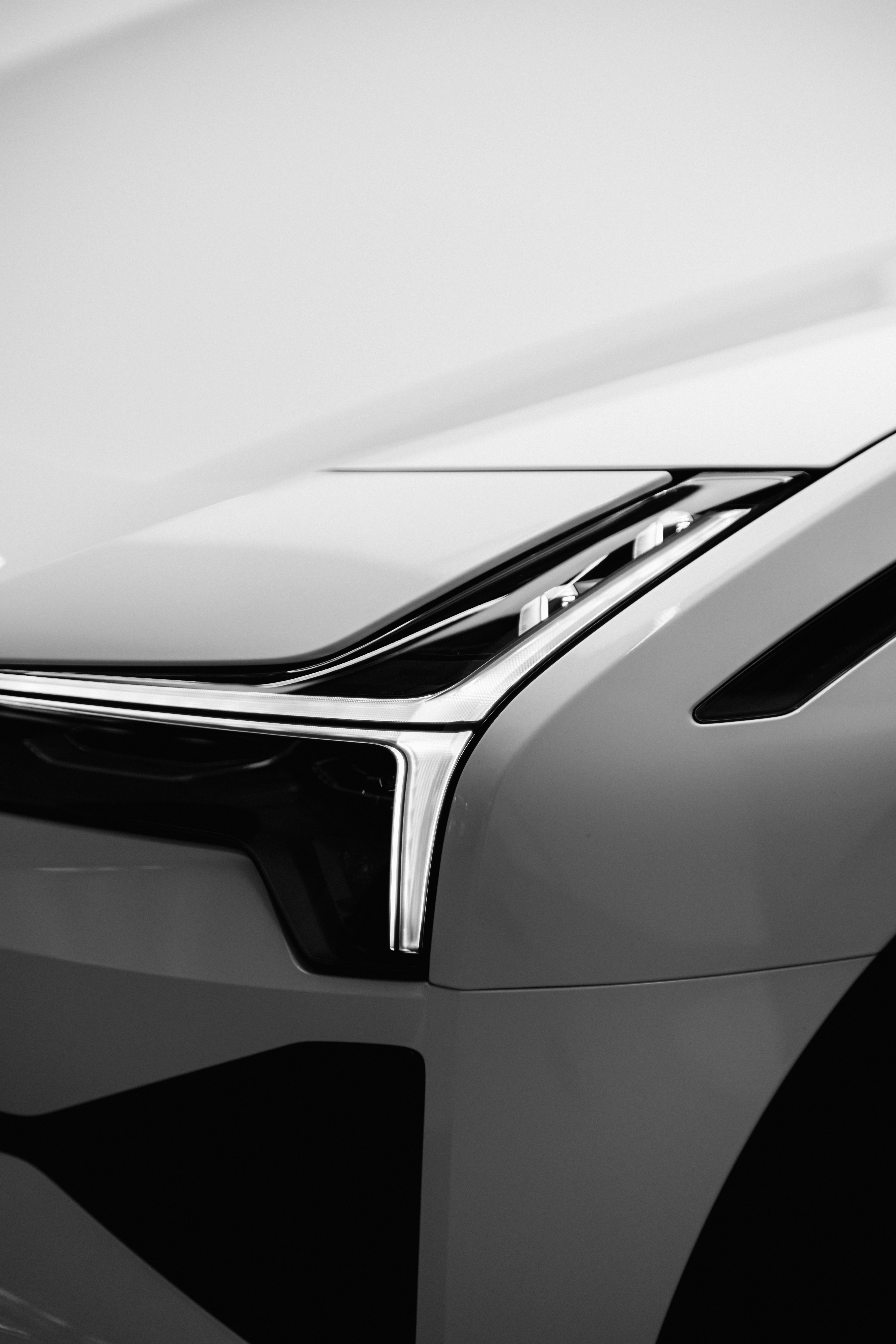 Black-and-white close-up of a vehicle headlight