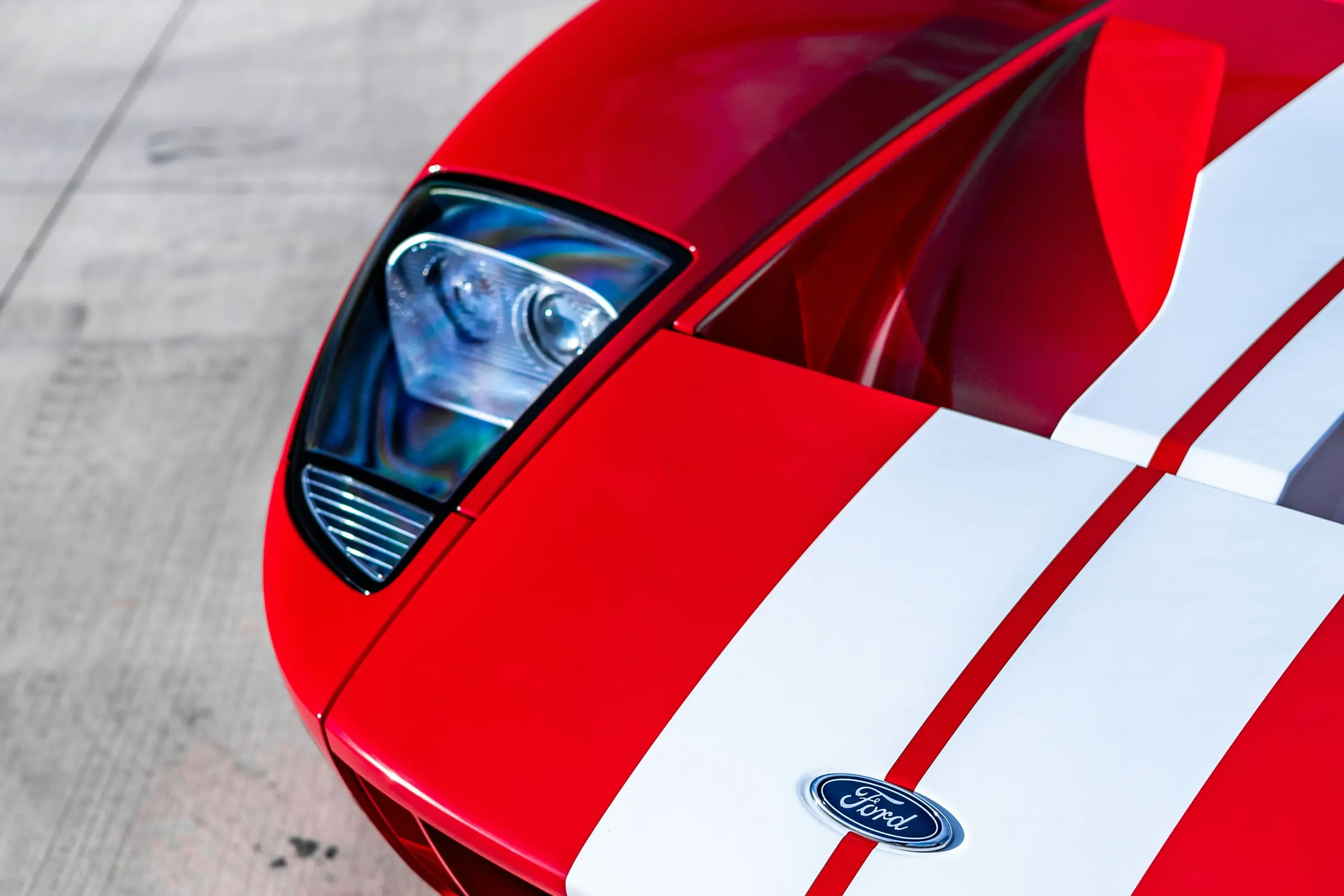 Close-up of a red Ford GT with white racing stripes