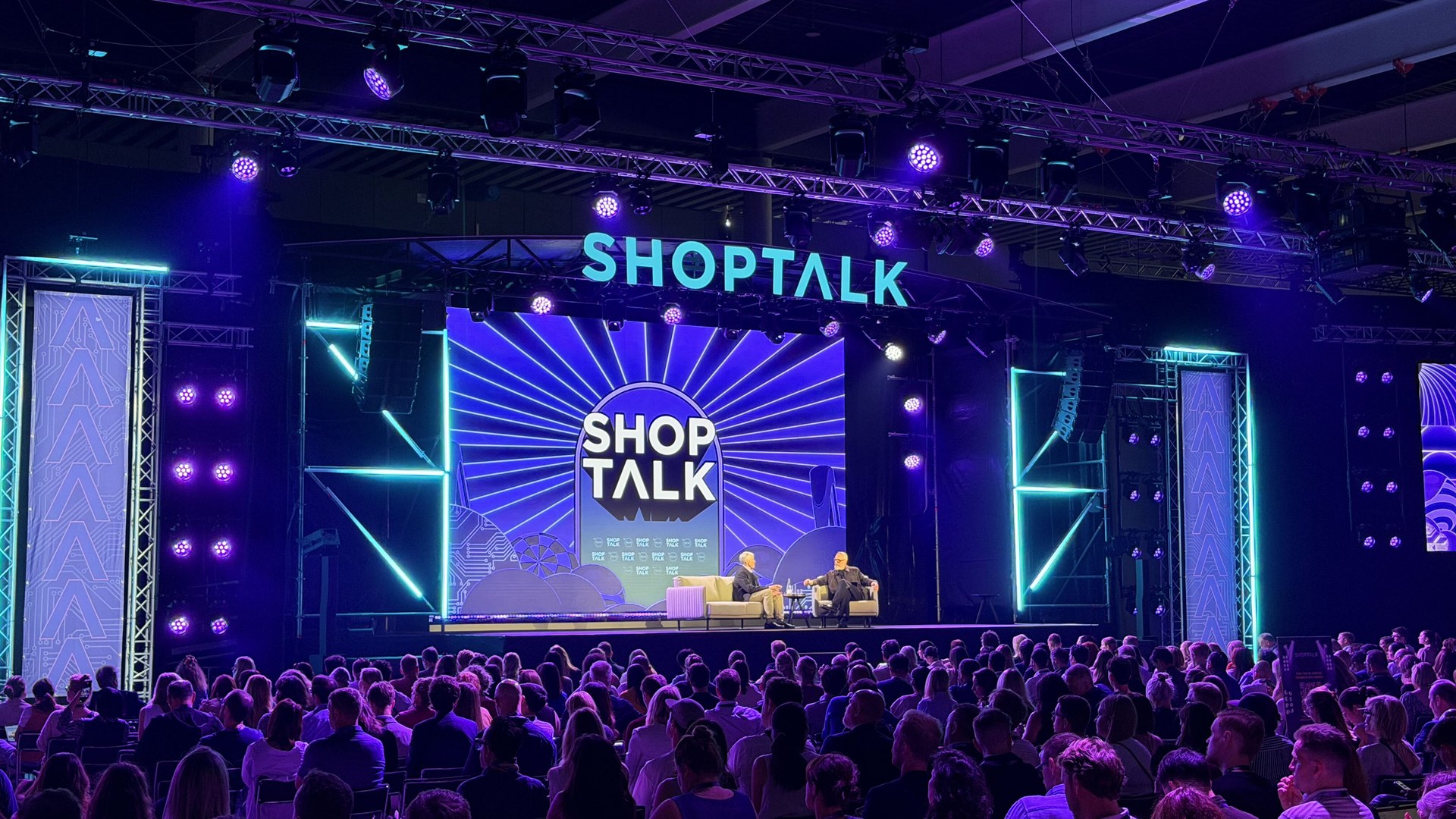 Shoptalk Europe 2026 stage in Barcelona with purple and teal lighting